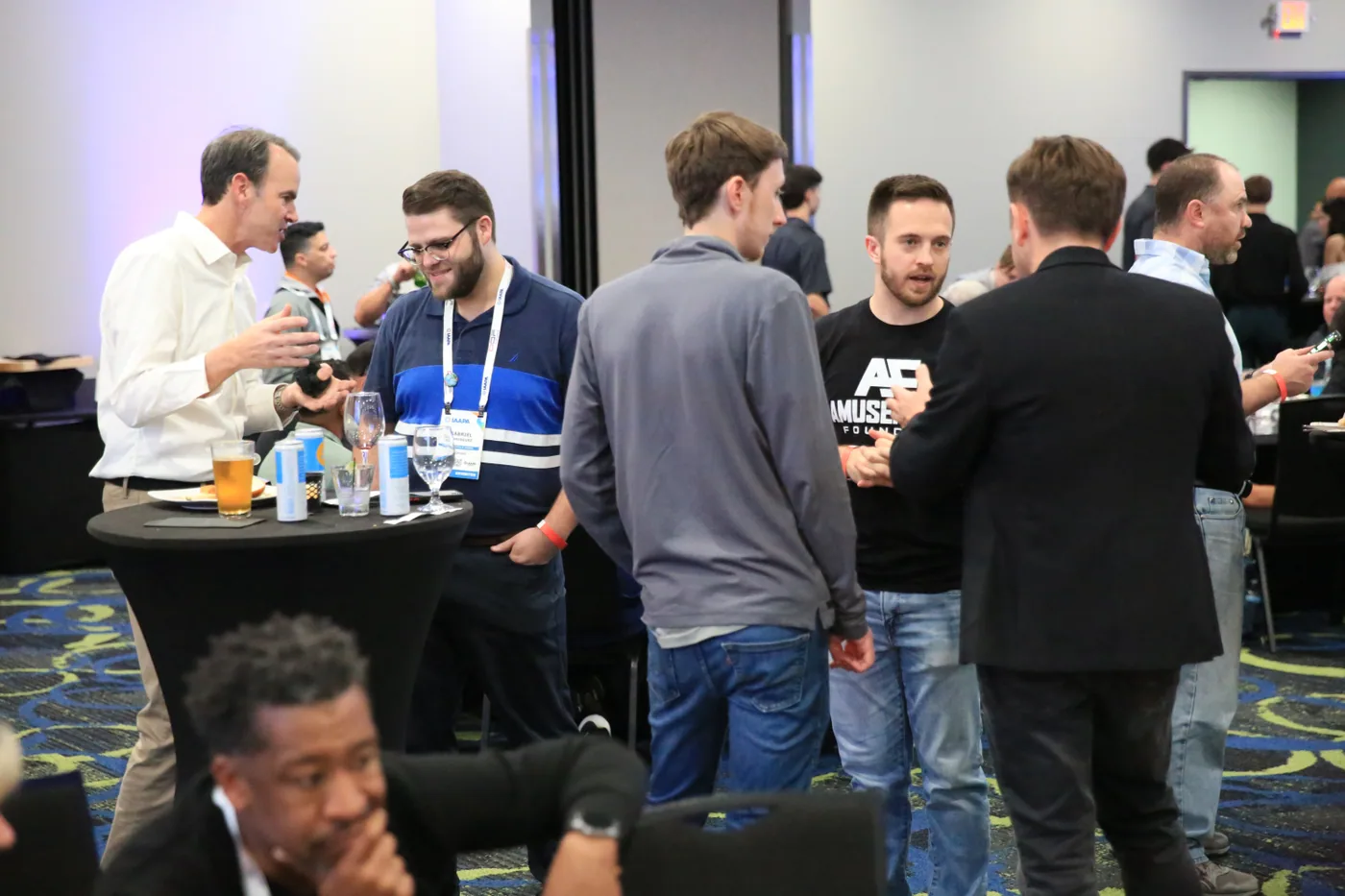 Attraction industry guests talking over drinks at The Big Show Wrap-Up
